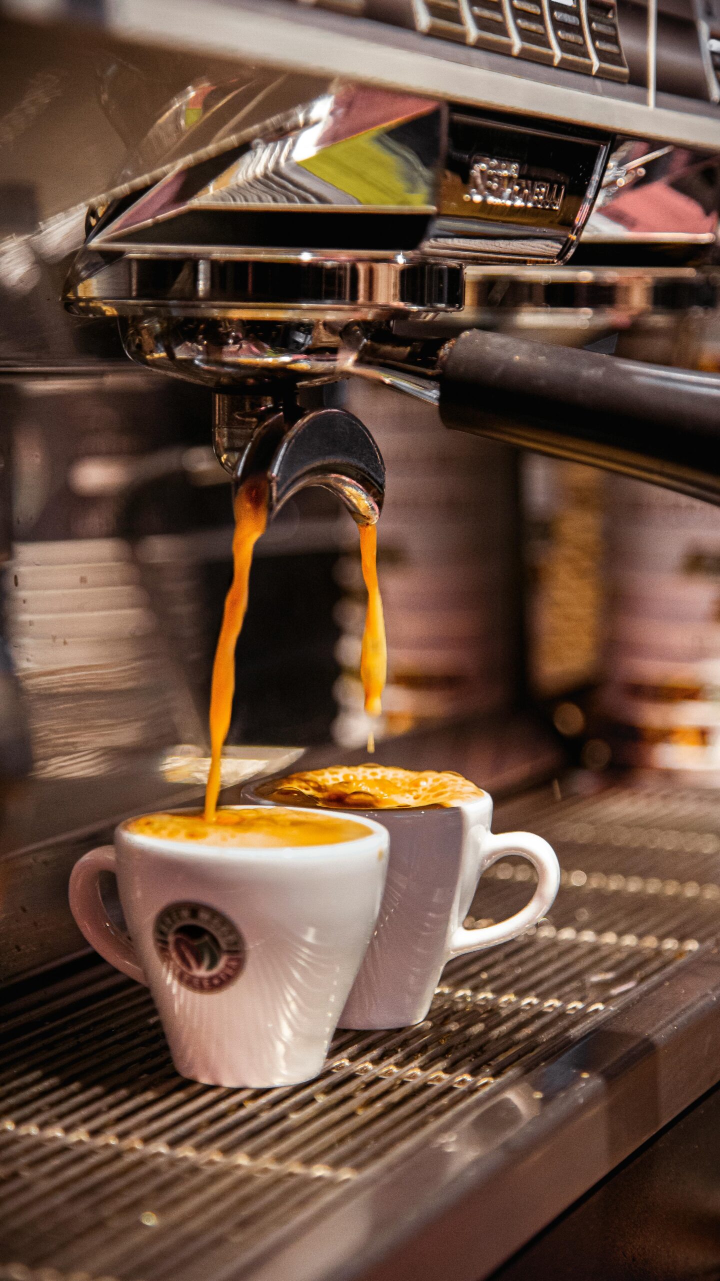 Home Close-up of espresso being poured into cups from a coffee machine in Izmir, Türkiye.
