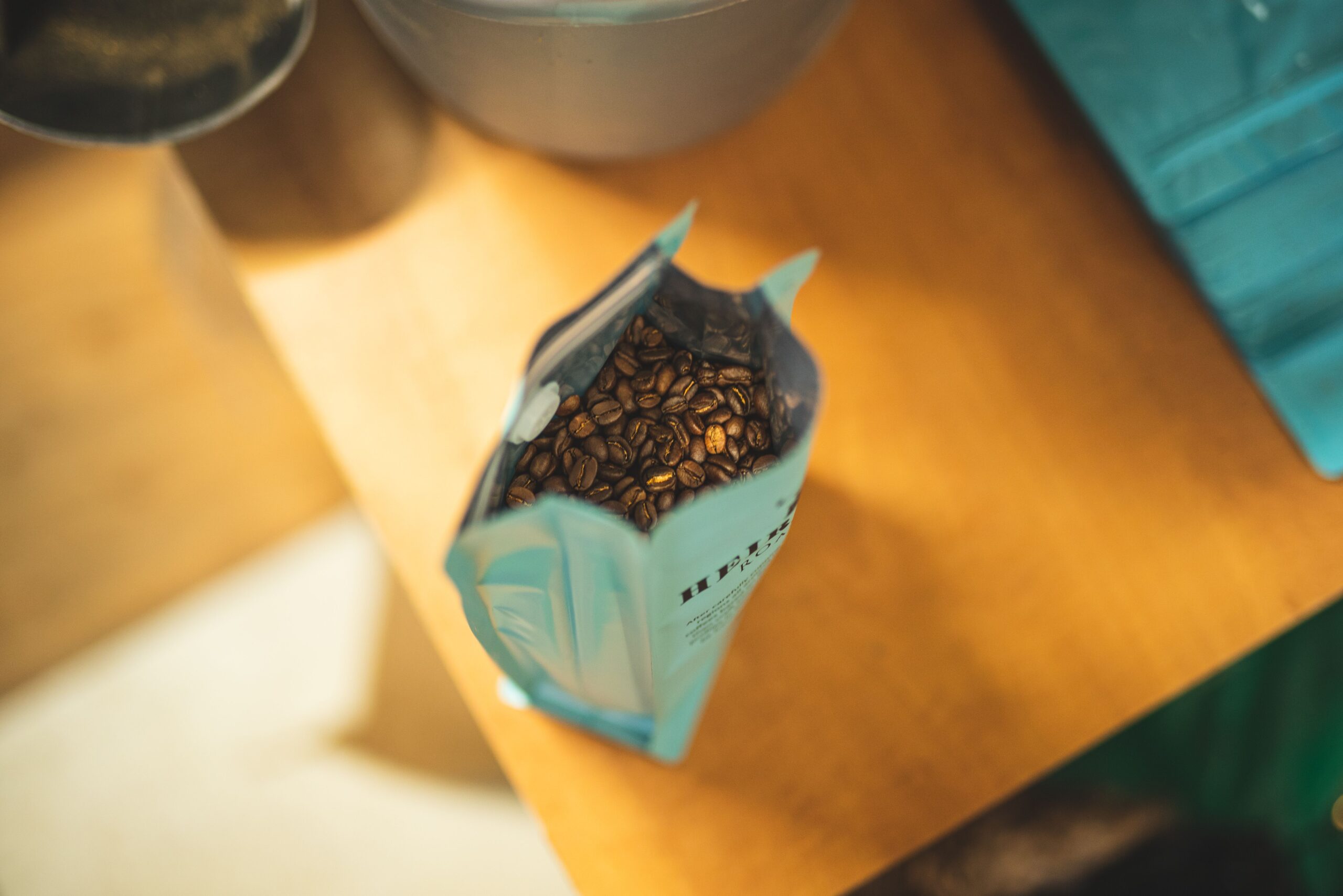 Home Overhead shot of an opened coffee bag showing fresh roasted beans.